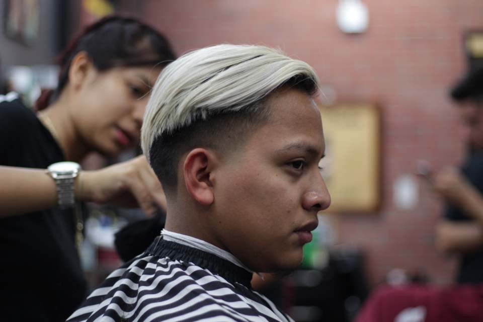 Platinum silk top over a faded undercut, mid-cut at the station