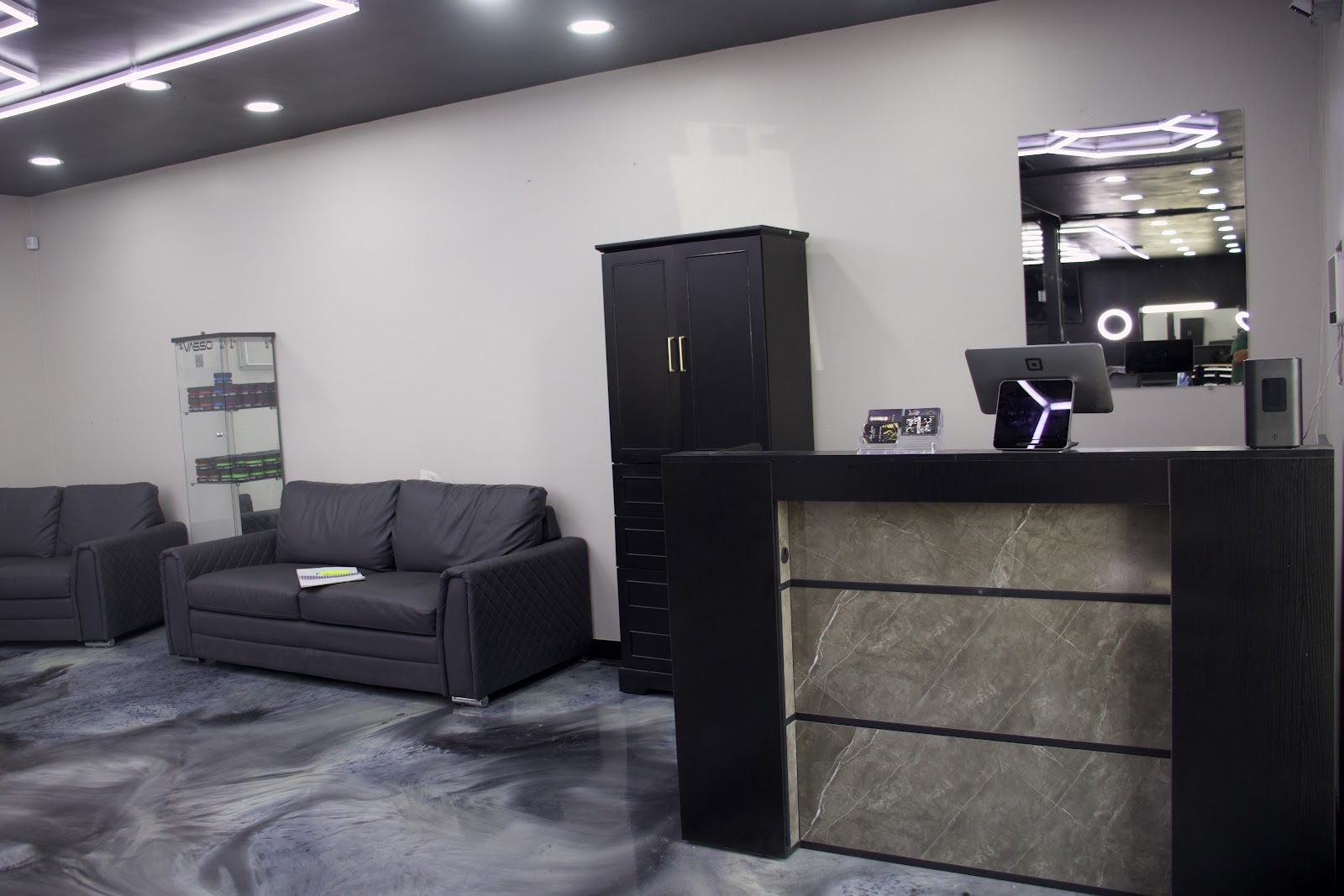 The Royal Fadez lounge: quilted leather couches, product case and the marble front desk